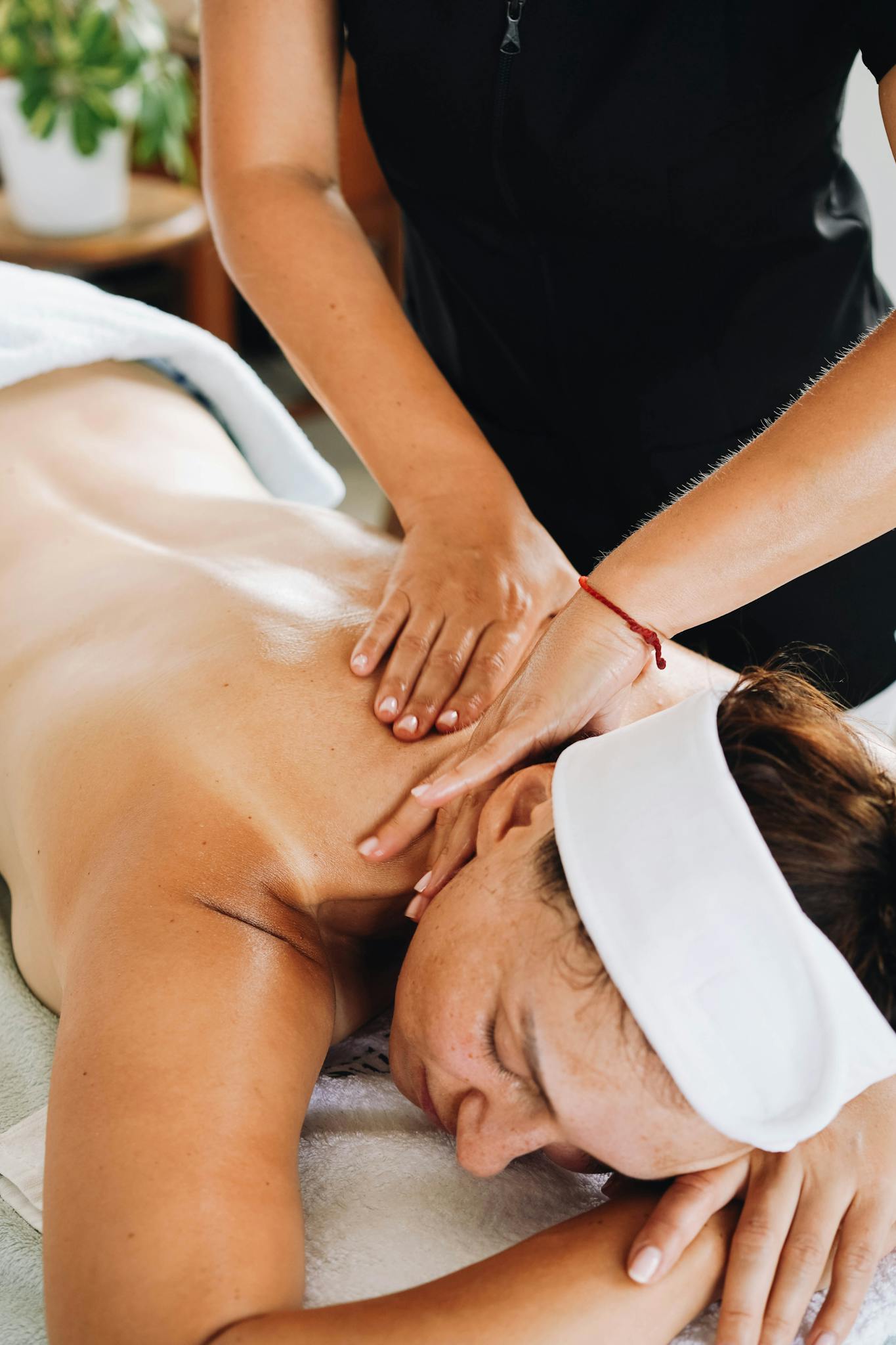 A woman enjoys a calming massage in a relaxing spa environment.